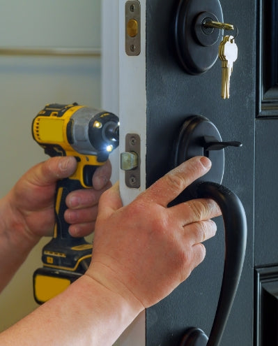 handyman fixing doorhandle